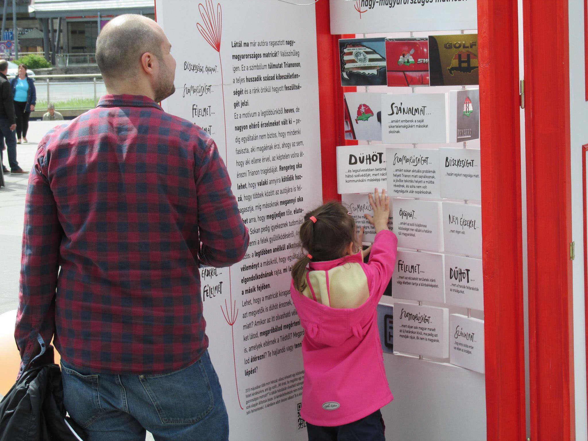 man and little girl looking at one of the exhibition doors